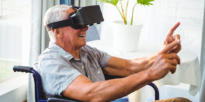 Smiling Senior Man in Wheelchair with VR Googles