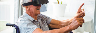 Smiling Senior Man in Wheelchair with VR Googles