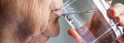 Senior woman drinking water - battling dehydration among seniors